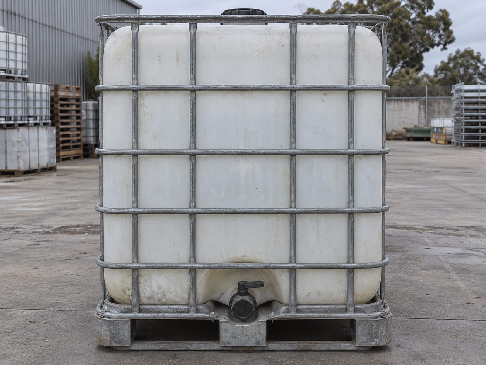 Example of a used 1000 L IBC tank in its steel cage, front view